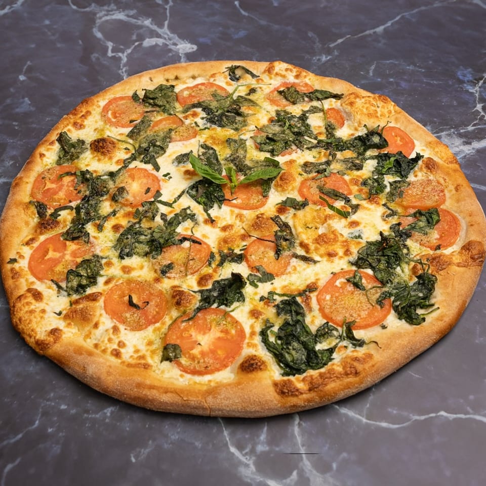 Rocco's Pizza with a golden crust, topped with melted cheese, sliced tomatoes, and spinach.